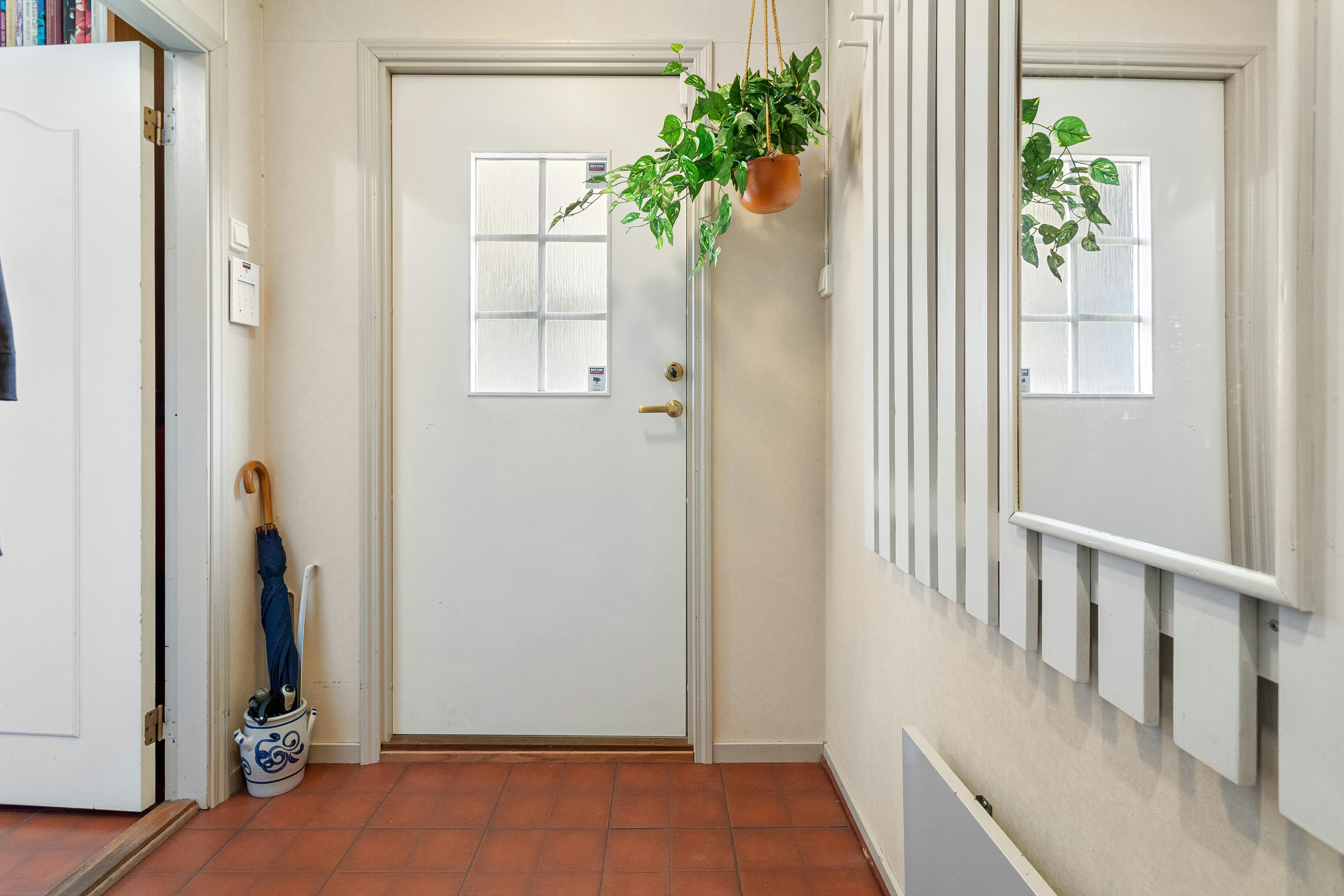 A hallway with a white door and a brown floor